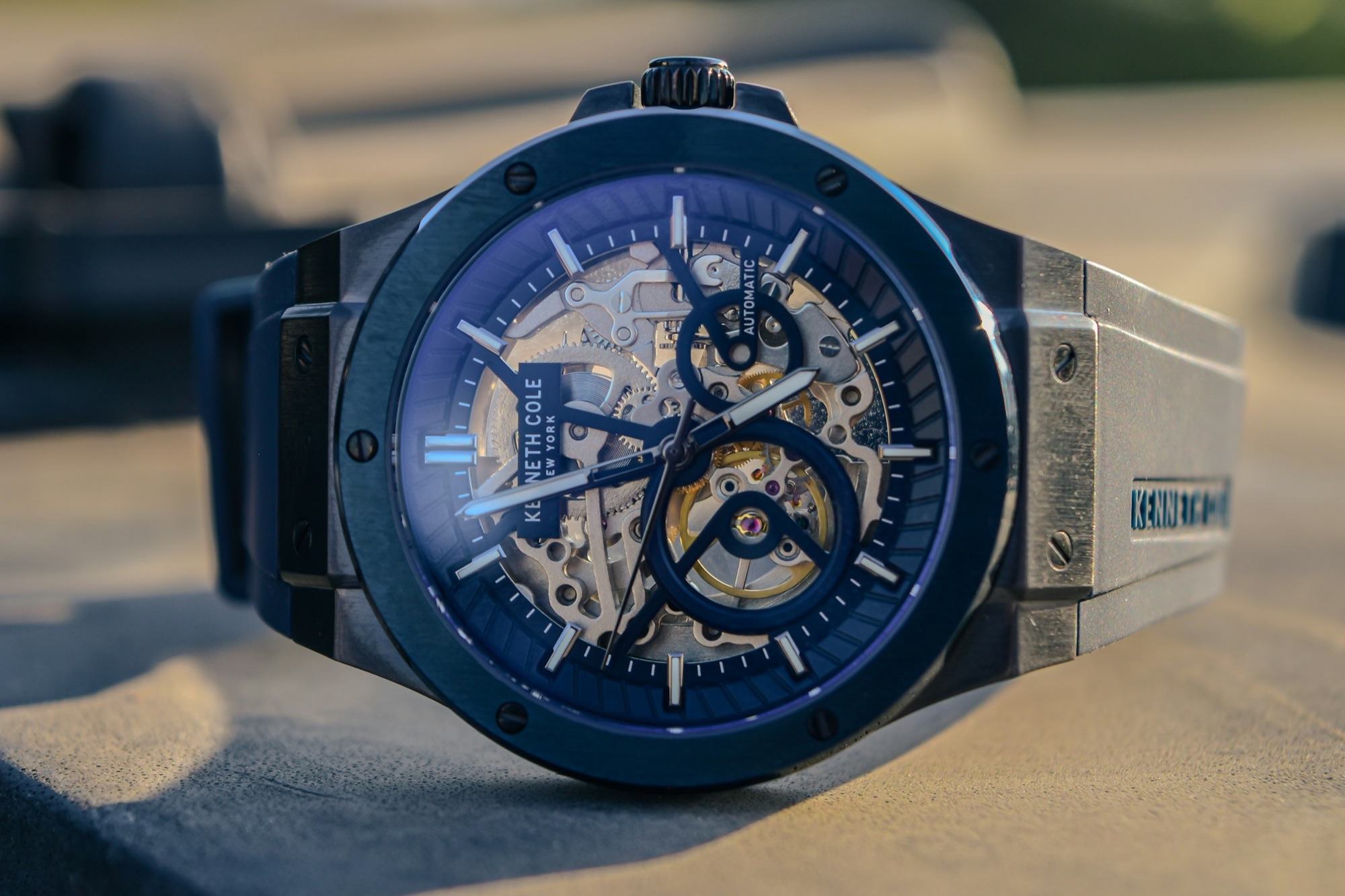 A blue skeleton automatic watch showing its exposed mechanical movement and gears